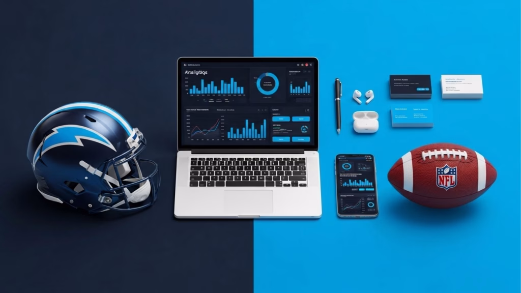 Uma mesa com um capacete de futebol americano, laptop exibindo gráficos e estatísticas, um smartphone, AirPods, caneta e cartões de visita, ao lado de uma bola de futebol americano com o logo da NFL.